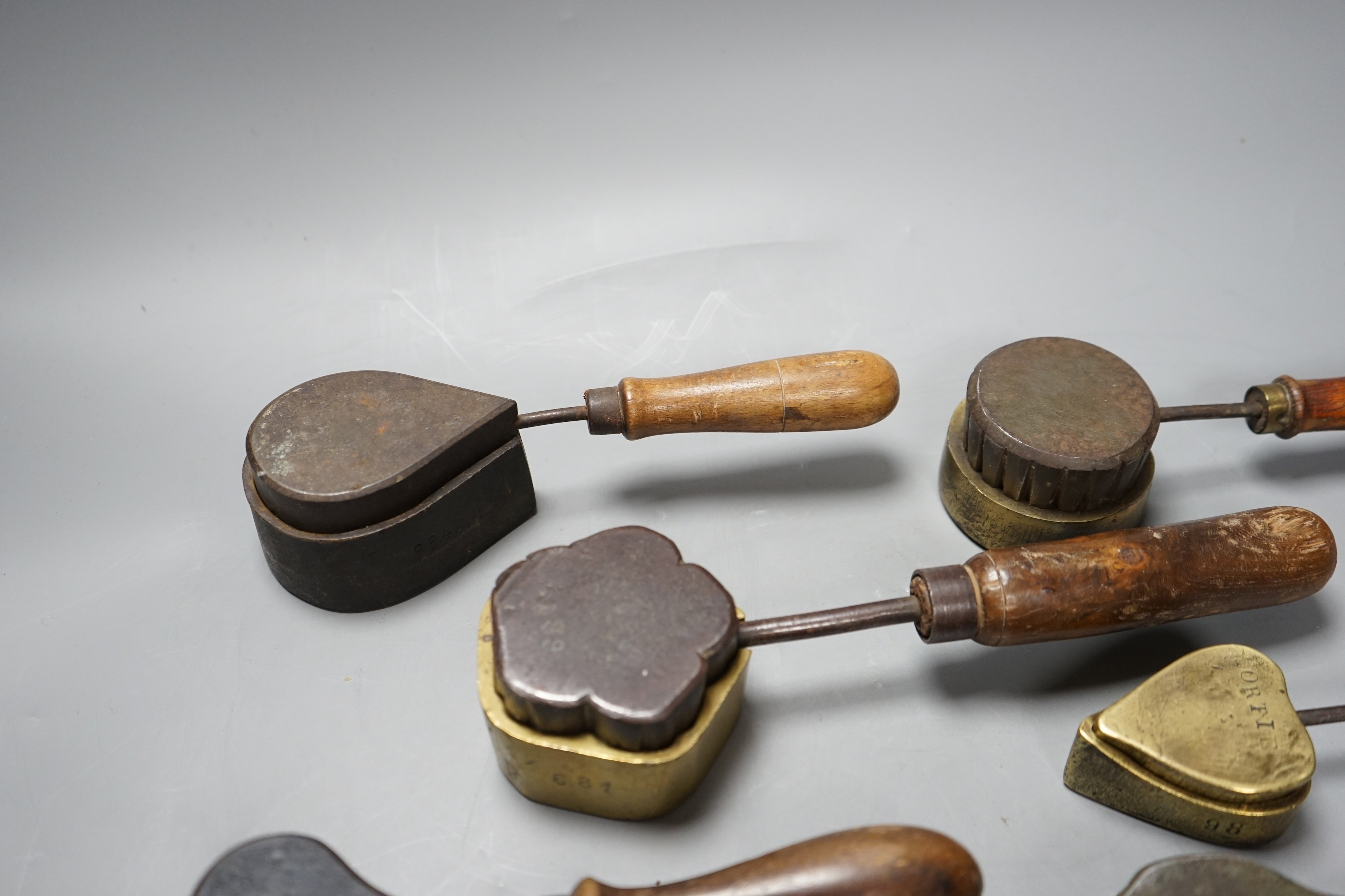 A collection of eight 19th century cast metal moulds for possibly hand embossing silk